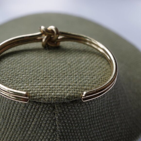 Women`s gold tone knot cuff bracelet. 2 1/2in. ID - Picture 4 of 5